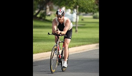 Jason riding a bicycle during a triathlon event