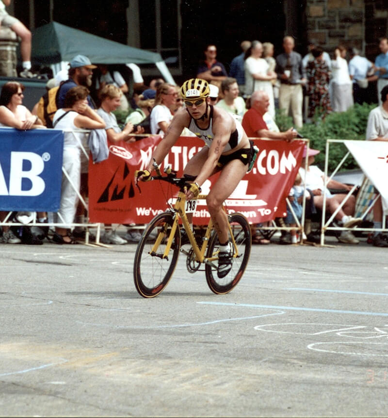 Jason riding a bicycle during a triathlon event